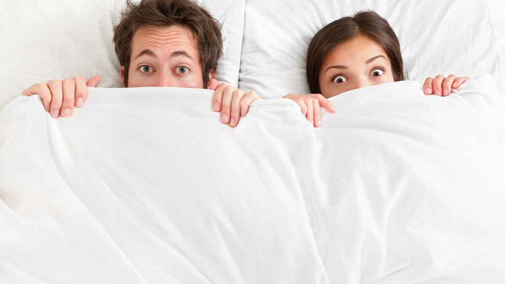 scared couple in bed